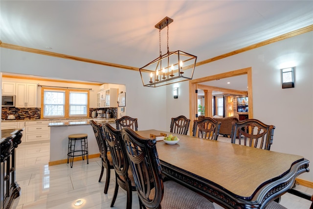 dining space with crown molding