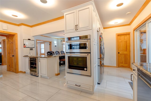 kitchen with stainless steel appliances, beverage cooler, light stone countertops, and white cabinets