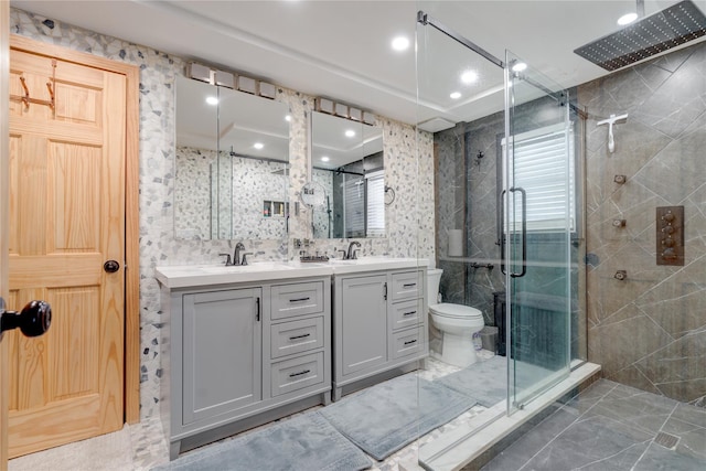 bathroom with vanity, toilet, tile walls, and walk in shower