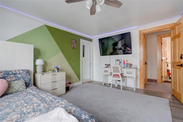 bedroom featuring ceiling fan, crown molding, and light wood-type flooring