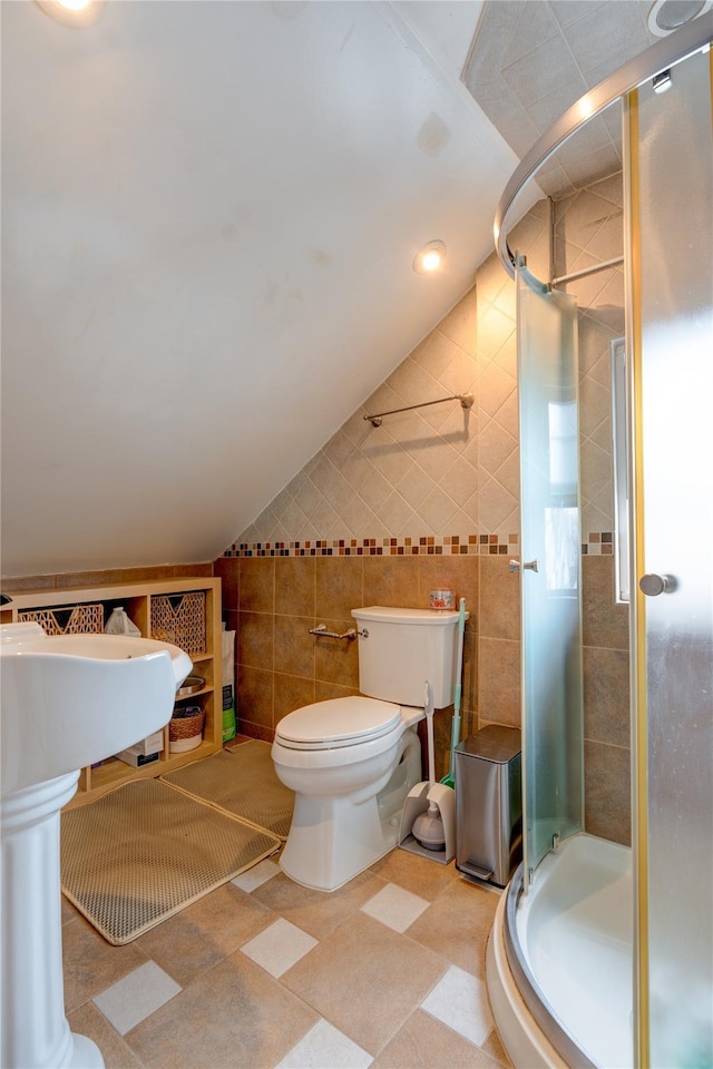 bathroom featuring sink, tile walls, an enclosed shower, vaulted ceiling, and toilet