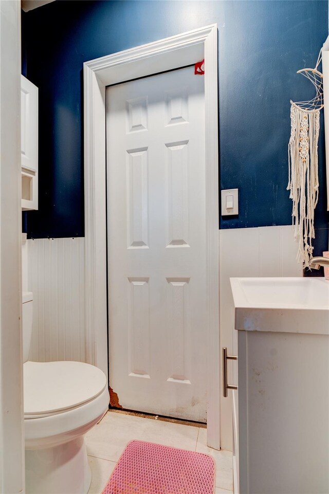 bathroom with vanity, tile patterned floors, and toilet