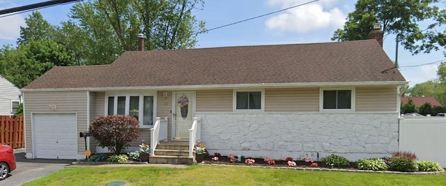 view of front of home featuring a garage and a front lawn