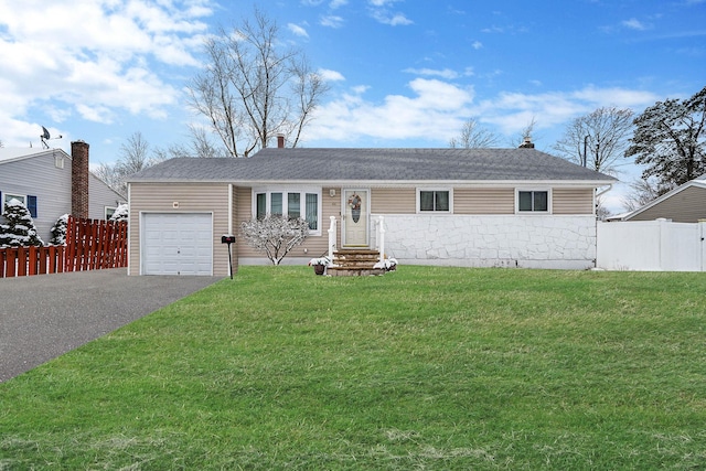 single story home featuring a garage and a front lawn