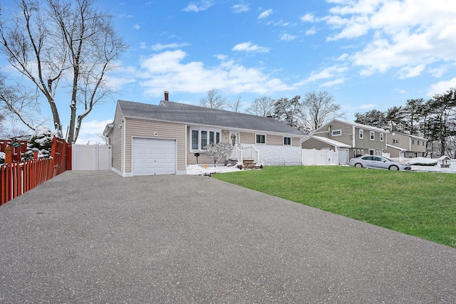 single story home featuring a garage and a front lawn