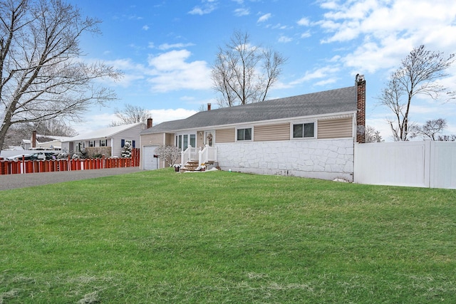 view of front of house with a garage and a front yard