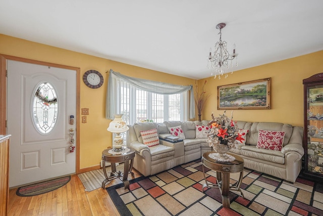 living room featuring an inviting chandelier and light hardwood / wood-style flooring