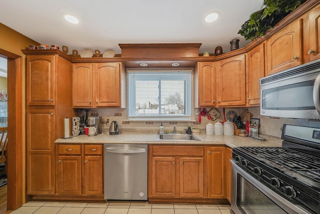 kitchen featuring appliances with stainless steel finishes, sink, and light tile patterned floors