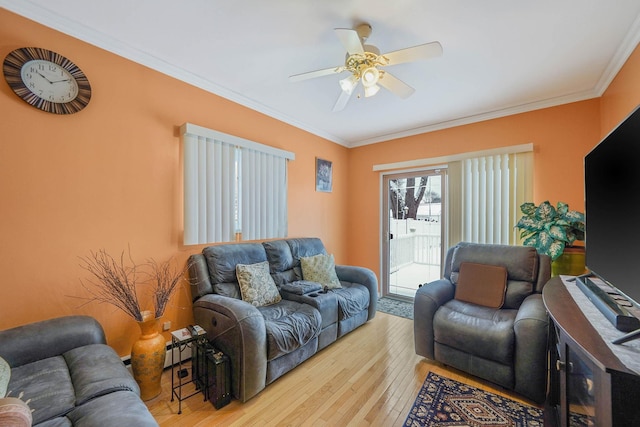 living room featuring ornamental molding, ceiling fan, light hardwood / wood-style floors, and baseboard heating