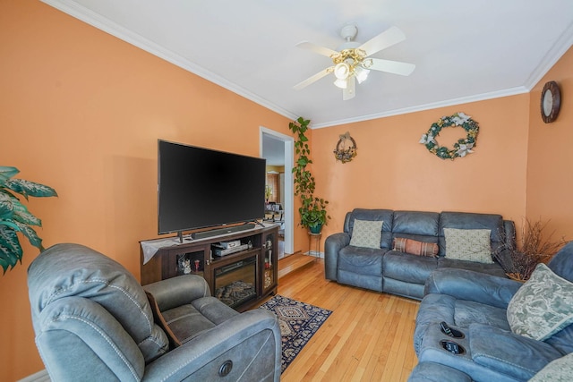 living room with crown molding, ceiling fan, and hardwood / wood-style floors