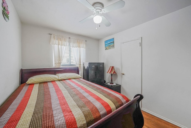 bedroom with hardwood / wood-style flooring and ceiling fan