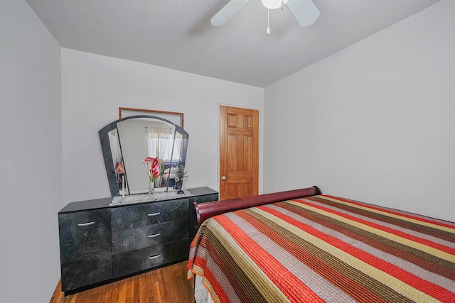 bedroom with dark hardwood / wood-style floors and ceiling fan