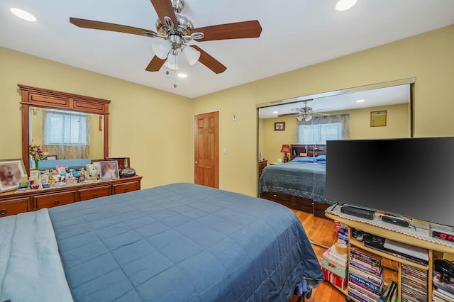 bedroom with ceiling fan and light hardwood / wood-style flooring