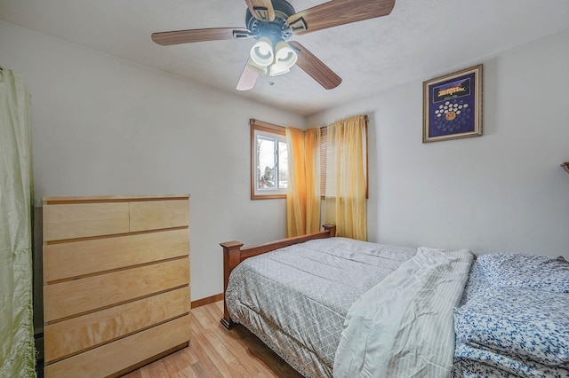 bedroom featuring light hardwood / wood-style floors and ceiling fan