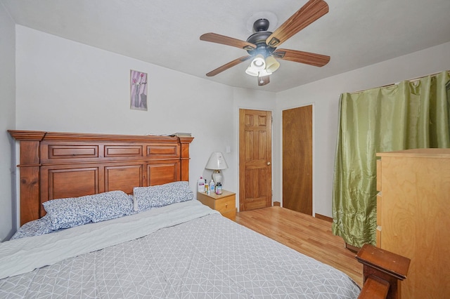 bedroom featuring hardwood / wood-style flooring and ceiling fan