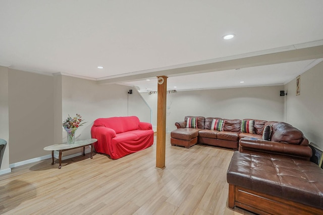 living room featuring crown molding and light hardwood / wood-style flooring