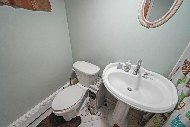 bathroom featuring toilet and tile patterned flooring