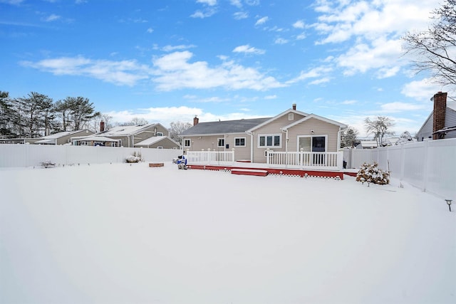 snow covered property with a wooden deck