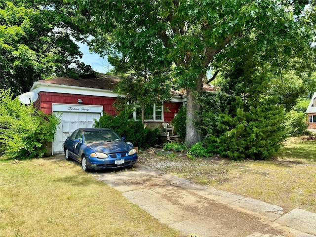 obstructed view of property with a front lawn