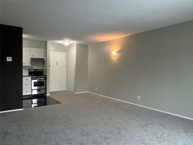 interior space with stainless steel range, white cabinets, and carpet flooring