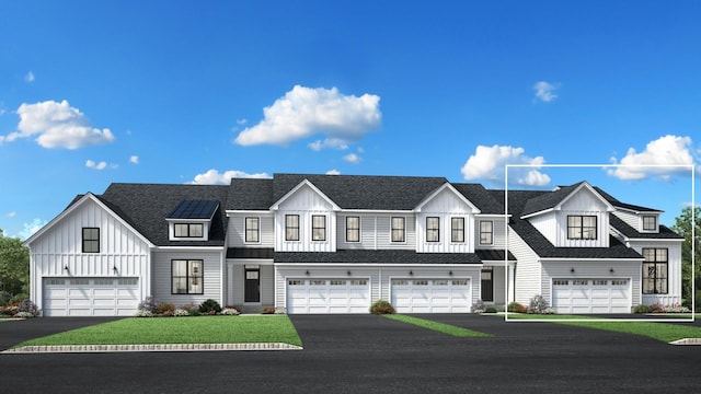 view of front facade with a garage, driveway, a shingled roof, and board and batten siding