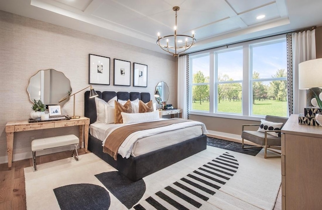 bedroom with a chandelier, recessed lighting, coffered ceiling, wood finished floors, and baseboards