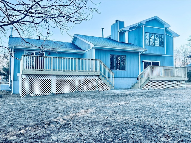 back of property with a wooden deck