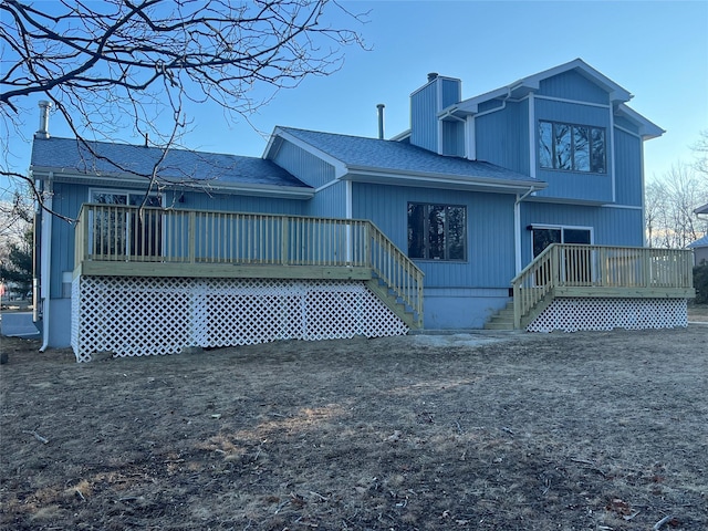 rear view of property with a wooden deck