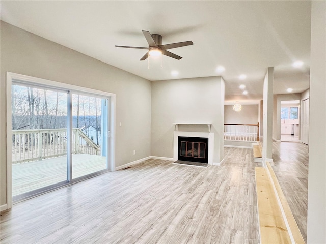 unfurnished living room featuring light hardwood / wood-style floors and ceiling fan