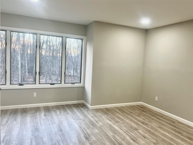 unfurnished room with light hardwood / wood-style flooring