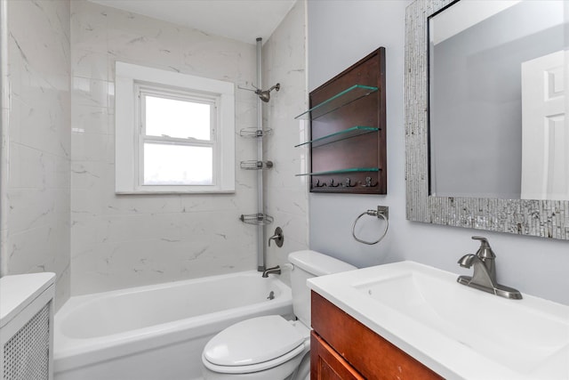 full bathroom featuring vanity, tiled shower / bath, and toilet