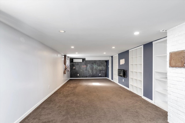 carpeted empty room featuring built in shelves