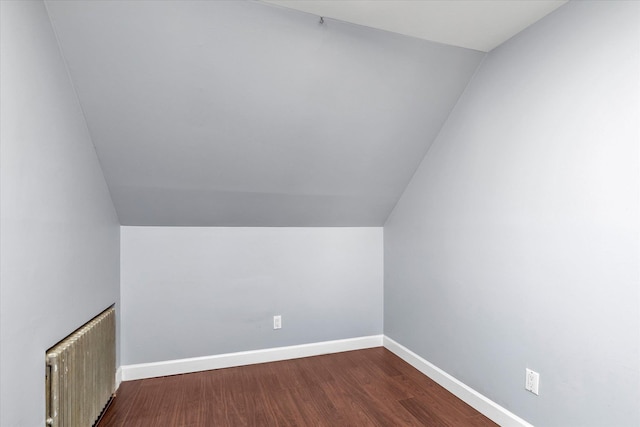 bonus room featuring hardwood / wood-style floors, radiator heating unit, and vaulted ceiling