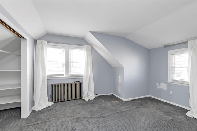 additional living space featuring carpet floors, radiator, and vaulted ceiling