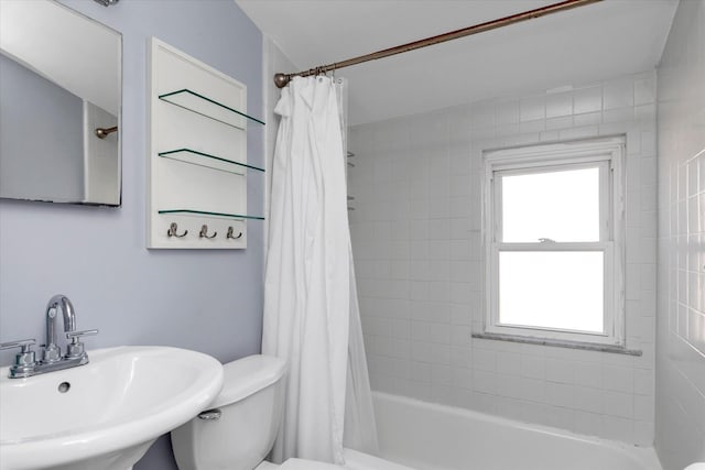 full bathroom with sink, shower / tub combo with curtain, and toilet