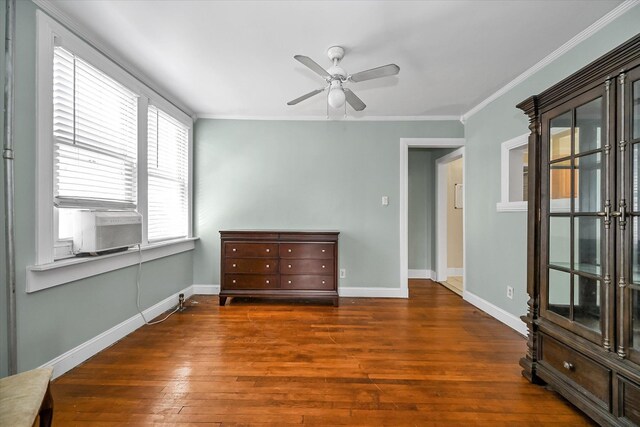 unfurnished room featuring dark wood-style flooring, crown molding, baseboards, and ceiling fan