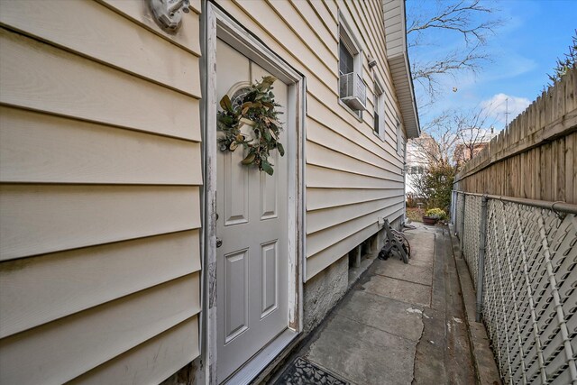 entrance to property featuring fence