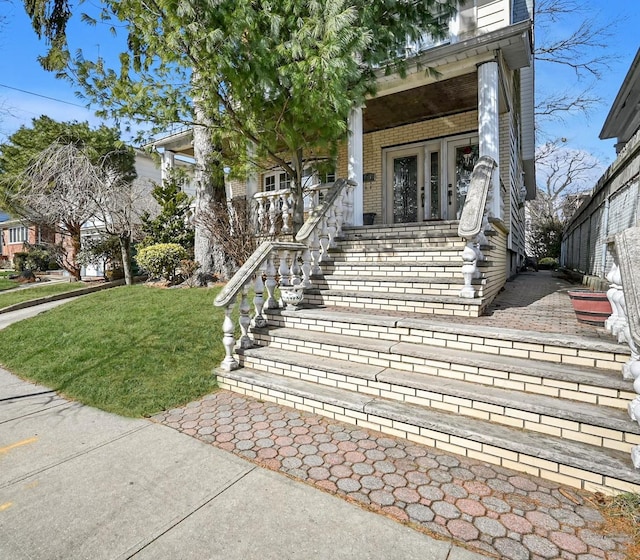 view of front of property featuring a porch and brick siding