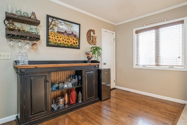 bar with hardwood / wood-style flooring and ornamental molding