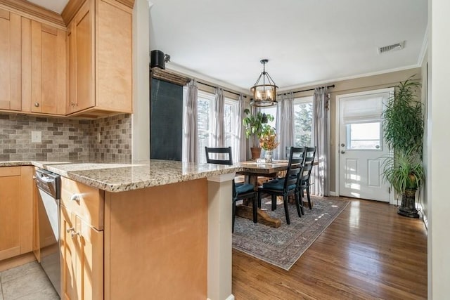 kitchen featuring tasteful backsplash, kitchen peninsula, light stone countertops, light brown cabinets, and light hardwood / wood-style flooring