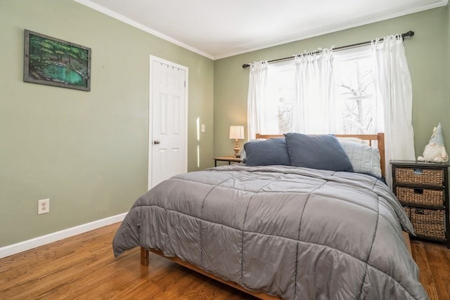 bedroom featuring hardwood / wood-style flooring and crown molding