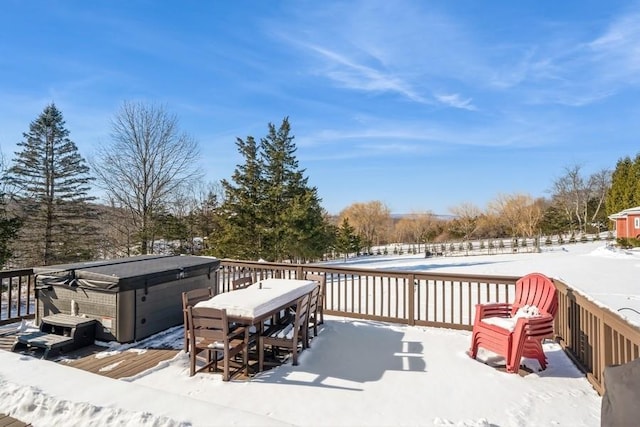 snow covered deck with a hot tub