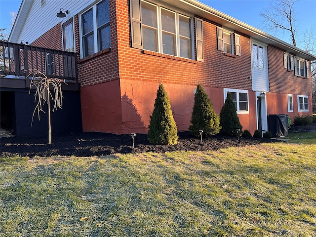 view of side of home with a yard