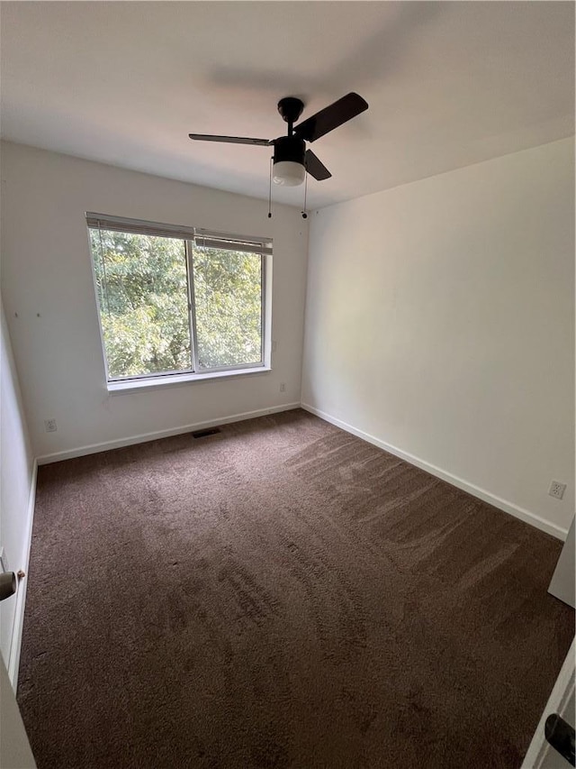 empty room with ceiling fan and carpet floors