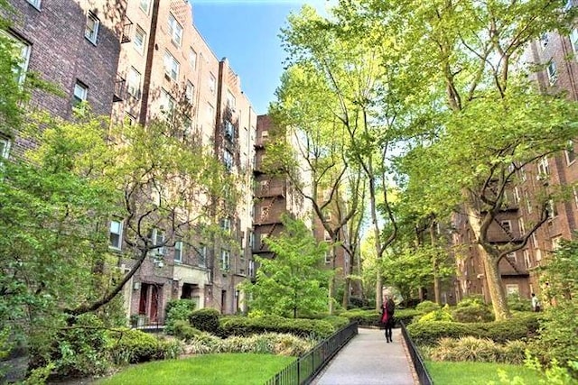 view of property's community with a lawn