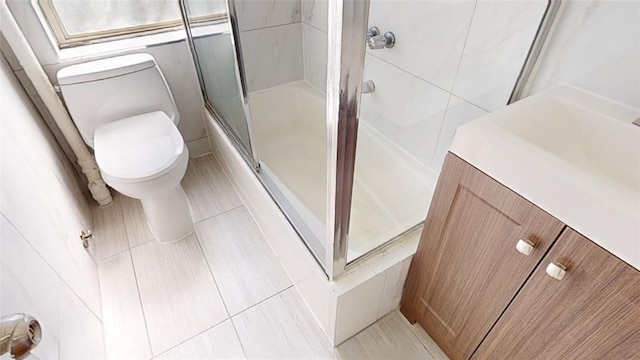 bathroom featuring tile patterned flooring, vanity, and toilet