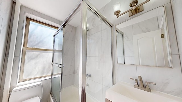 bathroom with tile walls, vanity, and toilet