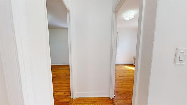 hallway with light hardwood / wood-style flooring