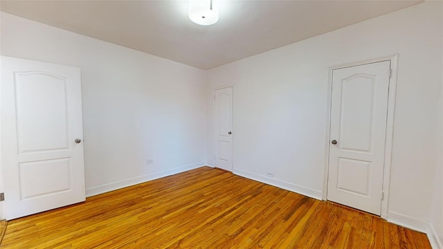 unfurnished room with light hardwood / wood-style floors