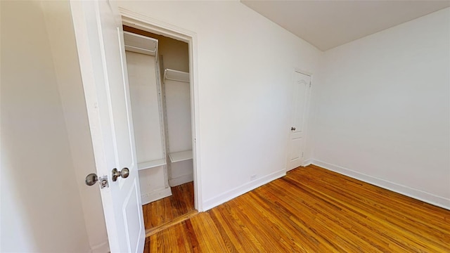 unfurnished bedroom with hardwood / wood-style flooring